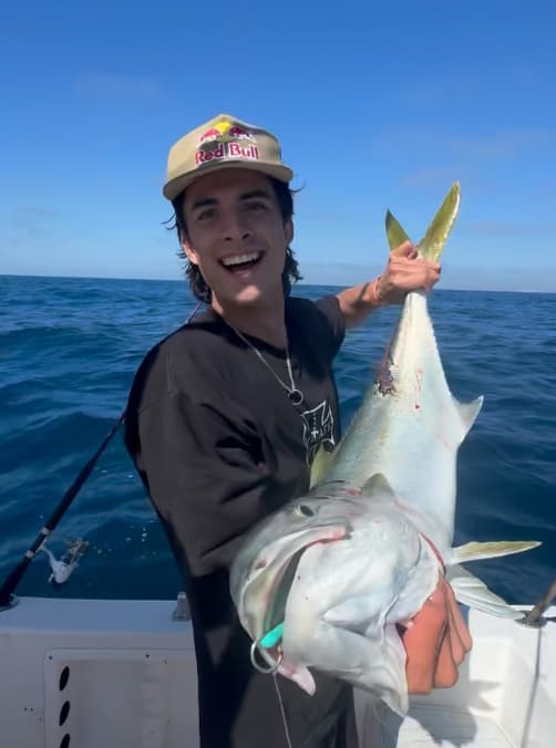 Seth Quintero holding a large fish while out on a boat