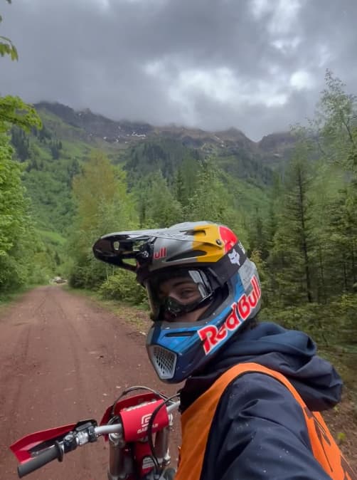 Seth Quintero on a dirt bike in the mountains, Red Bull helmet on