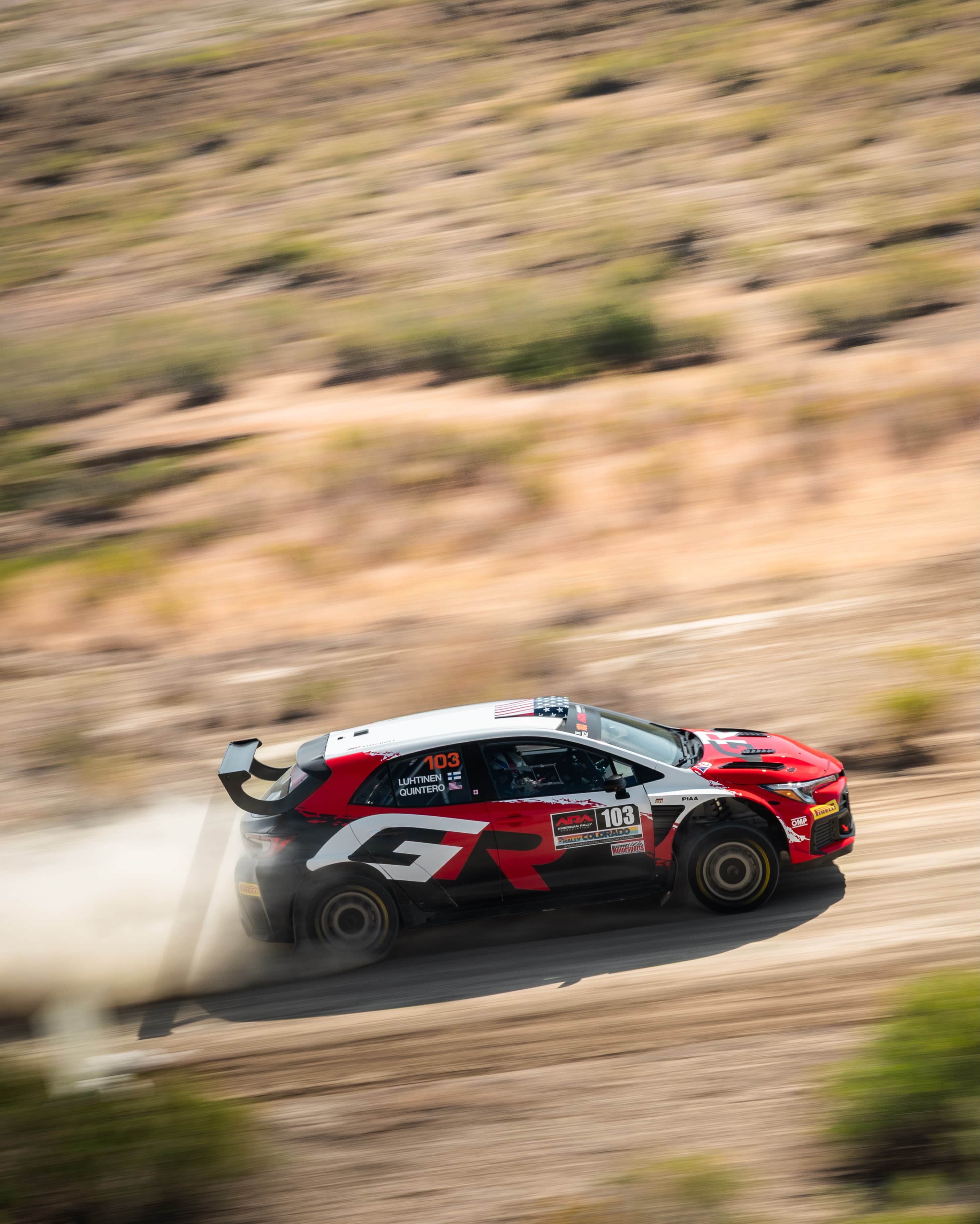 Seth Quintero's GR Corolla rally car sliding through a dusty stage